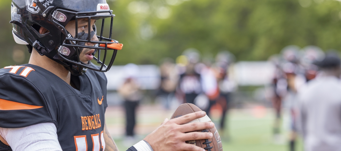 Male football player holding football