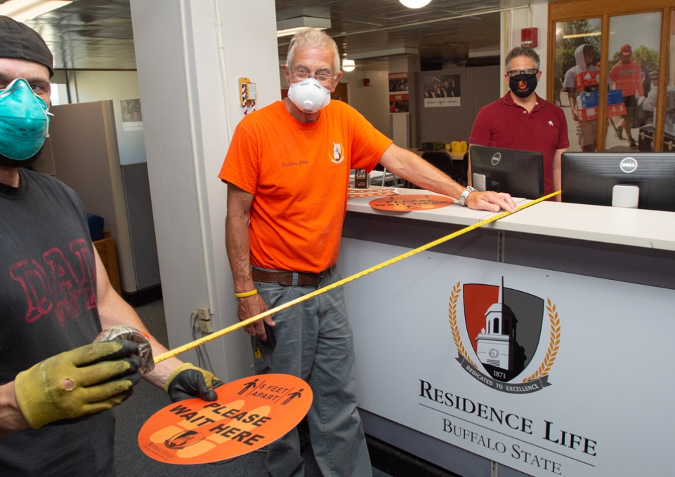 Facilities maintenance workers wearing masks