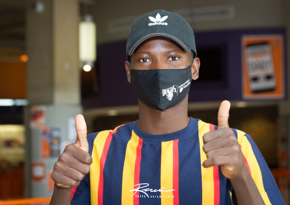 Buffalo State student wearing mask giving thumbs up